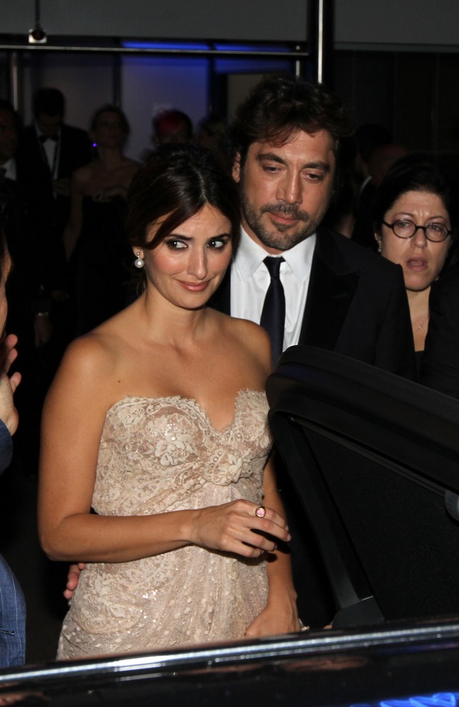 Penelope Cruz, champagne dress, strapless dress, earrings, ring, Javier Bardem, dark suit